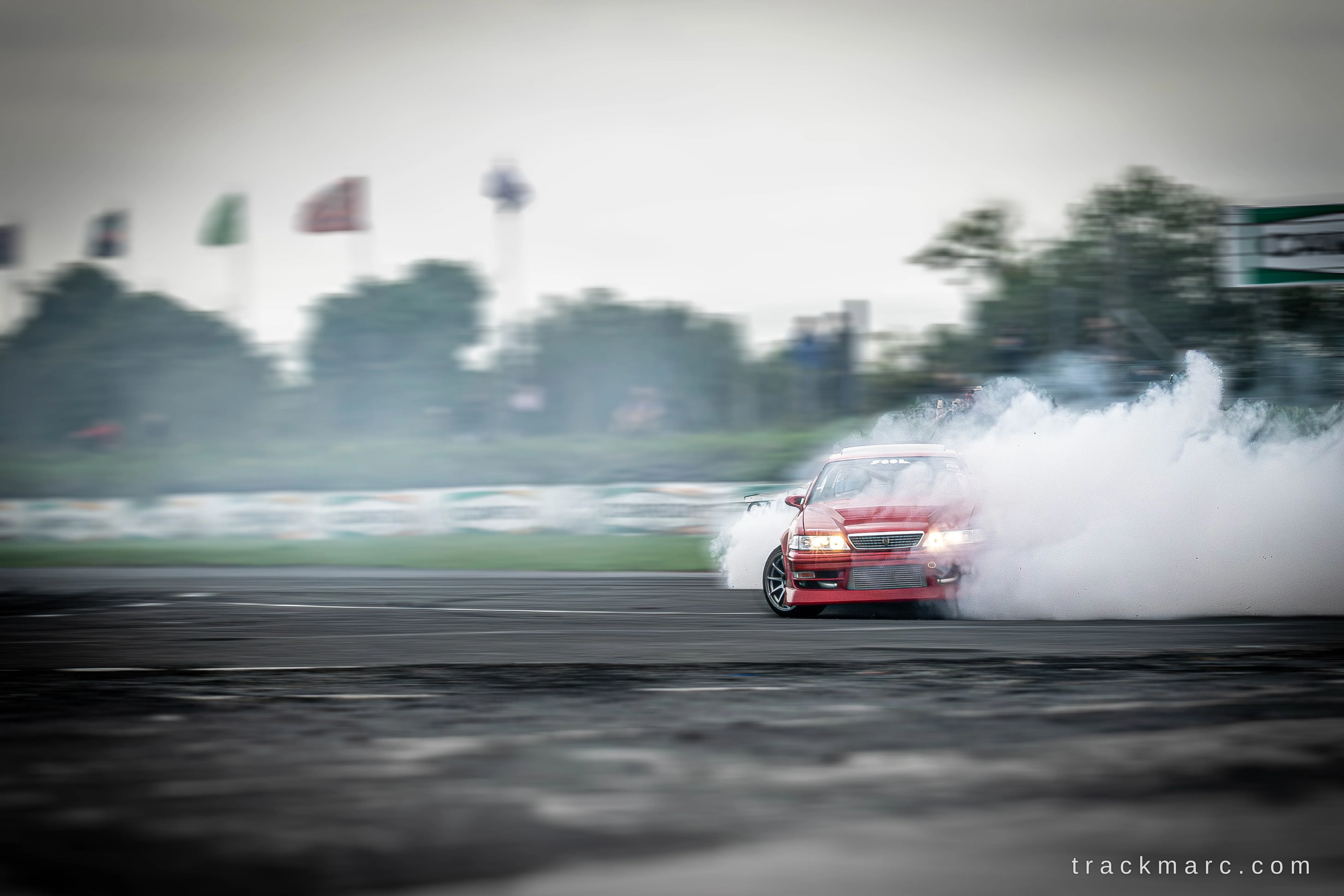 Red Toyota Chaser drifting at 86 Fest