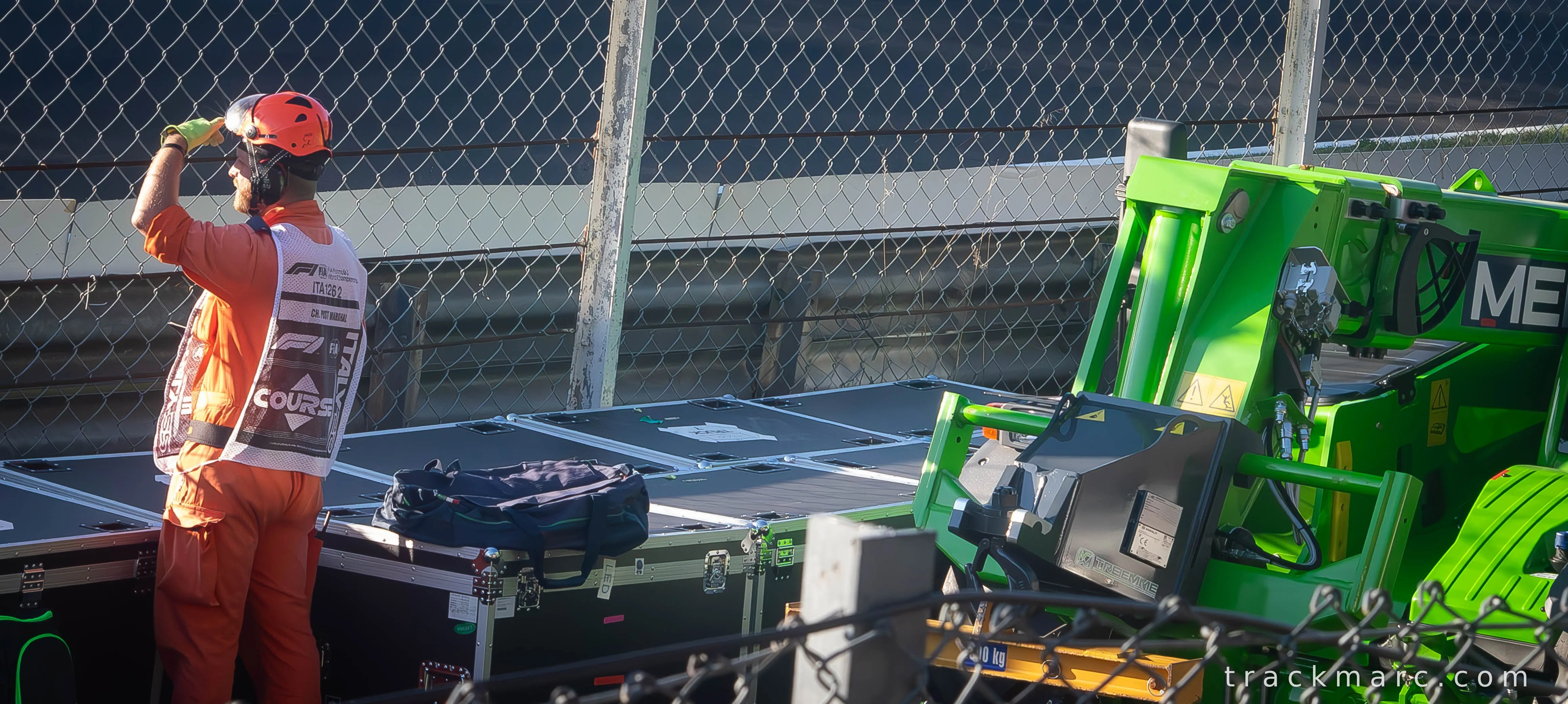 Formula 1 Pit Lane — Marshal or Crew Member Taking a Break