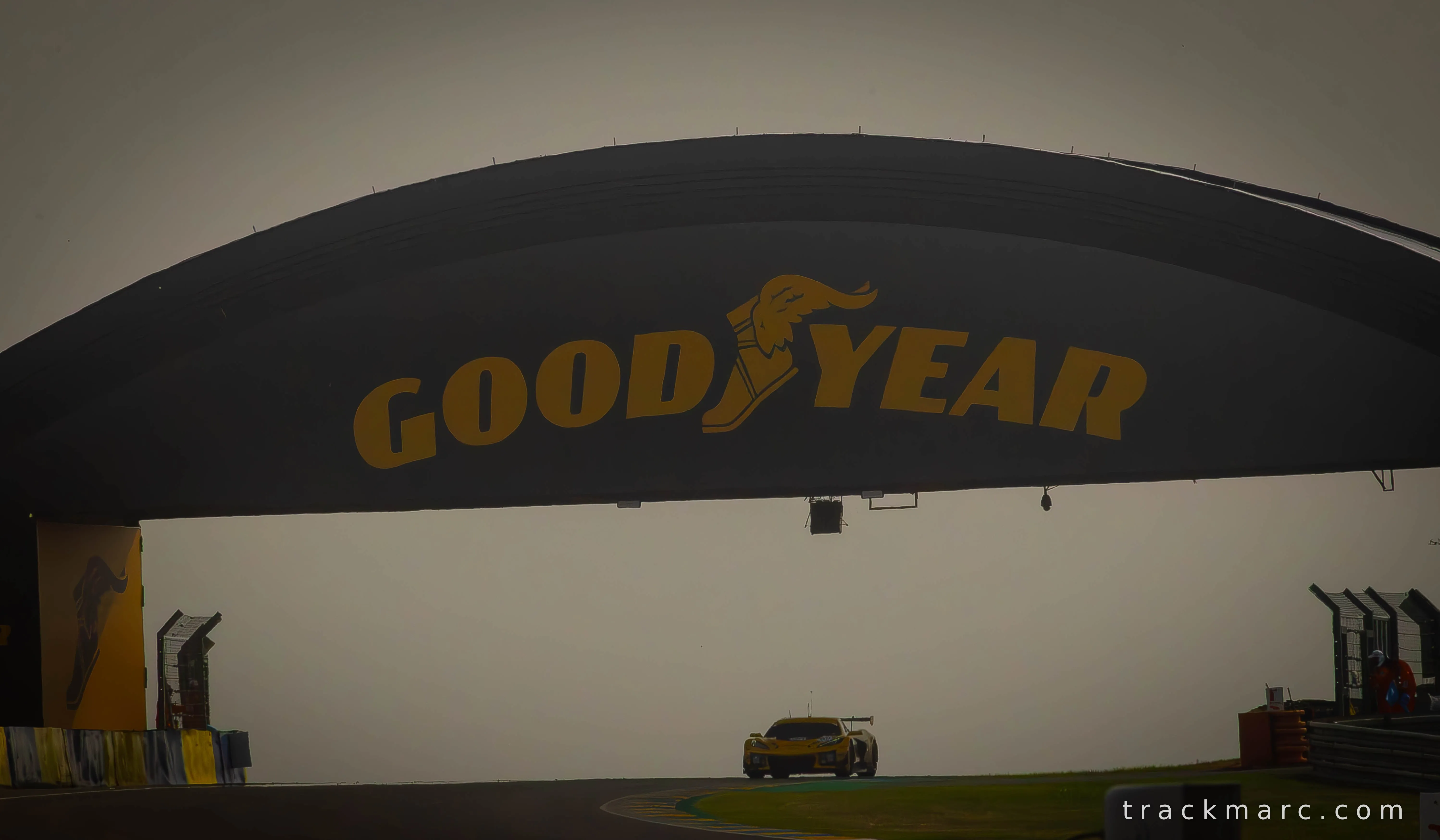 Yellow GT Car Beneath the Goodyear Arch — Le Mans 2026